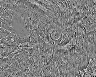 Arsia Mons and its surroundings in a THEMIS daytime infrared image mosaic. A huge fan-shaped expanse of knobby deposits (the Arsia Sulci), believed left by past glaciation, extends northwestward from the mountain.