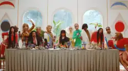 Camila Cabello is sitting next to the dinner table at the family party