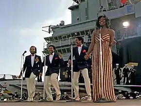 Gladys Knight & The Pips perform aboard the aircraft carrier USS Ranger on November 1, 1981. Left to right: William Guest, Edward Patten, Merald "Bubba" Knight, and Gladys Knight.