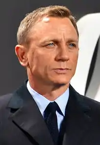 Colour photograph of Daniel Craig (in character as James Bond) sitting on yacht in 2006