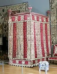 Baroque four-poster bed from the Château d'Effiat; c.1650; natural walnut, chiselled Genoa silk velvet and embroidered silks; 295 cm; Louvre