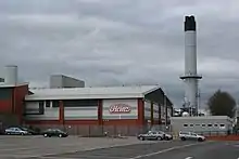 Image 11Heinz, although based in Hayes in Middlesex, has the largest food processing complex in Europe at a 55-acre (22&nbsp;ha) site at Kitt Green in Wigan, which produces 1.4&nbsp;billion cans of food each year; it is accessed to the east of the Orrell Interchange of the M6 (A577); the 38-acre Heinz NDC is next door (from North West England)