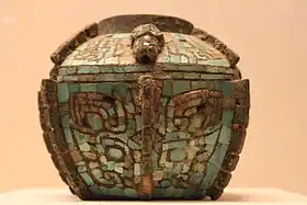 Late Shang bronze lei with turquoise taotie motif.