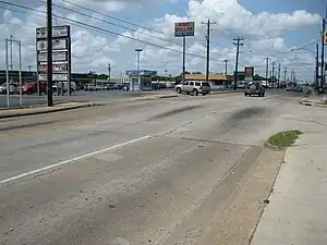 View is SW at Long Point Road and Lynnview. Upthrown side of the Long Point Fault is to the right. Fault passes to the left of the kiosk.