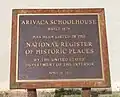The National Register of Historic Places marker at the front of the schoolhouse.