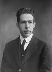 Head and shoulders of a young man in a suit and tie