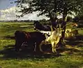 Two cows and a horse standing in the shade of a tree in a field. More seated cows in the background