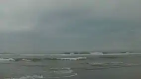 Ocean with breaking waves under a dark and stormy sky