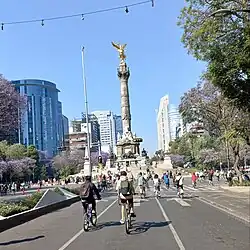 Bicyclists on road in front of landmark victory column