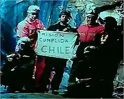 Slightly grainy color video capture image of the six rescuers displaying the famous "Mision Cumplida Chile" sign deep within San José Mine near Copiapo, ChileMisión cumplida: Chilean miners' ordeal comes to an end The Independent, London Guy Adams 14 October 2010