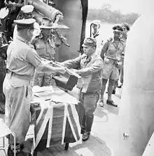 The official surrender ceremony of the Japanese to the Australian forces on board HMAS Kapunda at Kuching, Kingdom of Sarawak, on 11 September 1945