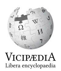 The logo of Latin Wikipedia, an incomplete sphere made of large, white, jigsaw puzzle pieces. Each puzzle piece contains one glyph from a different writing system, with each glyph written in black. The Latin Wikipedia wordmark displays the name Vicipædia, written in all caps. The V and the A are the same height and both are taller than the other letters which are also all the same height.