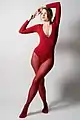 Woman wearing red tights that were produced on the same type of machinery as the bodysuit