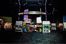 Museum interior, with displays in a large space and World Video Game Hall of Fame on a hanging sign.