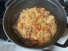 Cooked Zatarain's jambalaya with tomatoes and sausage in a pot.